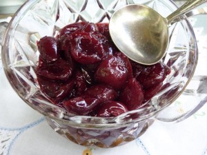 Spicy cherry sauce in a cut crystal bowl with silver serving spoon