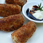 crumed and fried eggplant croquettes with a bowl of mayonnaise