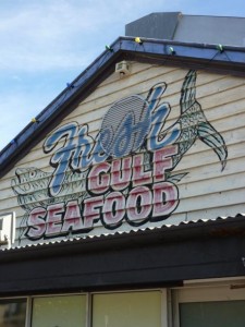 Faded sign painted on side of building for Fresh Guld Seafood in Fremantle, WA