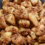 cubes of potatoes tossed in spices and coconut to create a dish of gujarati potatoes