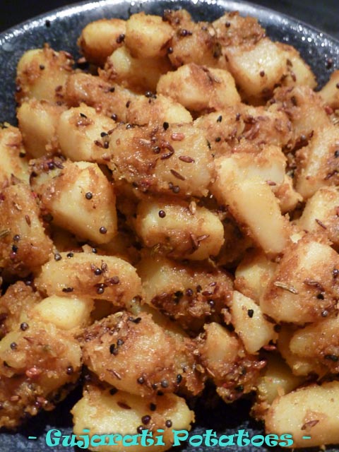 cubes of potatoes tossed in spices and coconut to create a dish of gujurati potatoes