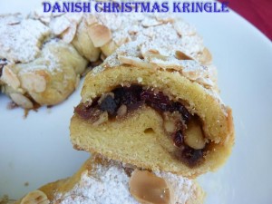 Danisk Christmas Kringle with cranberry folling dusted with icing sugar and flaked almonds