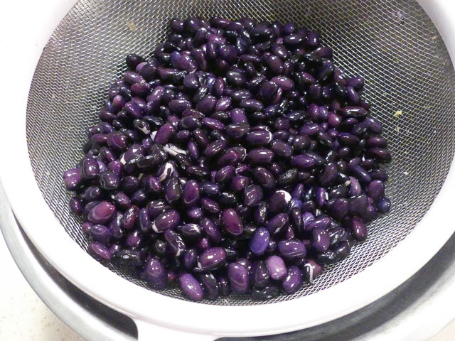 colander of purple hues black beans