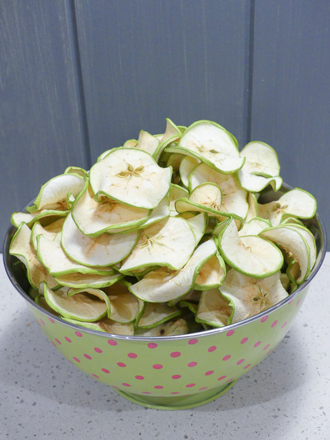 large green bowl of dried green apple slices