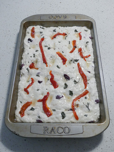 tray of uncooked red pepper and olive sourdough focaccia