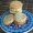 Pile of tahini cookies piled on top of a ceramic tile with reb, white and blue Middles Eastern pattern