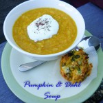 Bowl of pumpkin & dahl soup, topped with natural yoghurt and a pumpkin muffin as a side