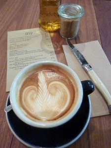 espresso coffee cup on a table with a menu, sugar bowl and knife