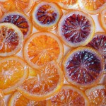 Sliced Glace Confit Blood Oranges flat in a baking dish