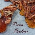 Pecan nuts in toffee on a tray.