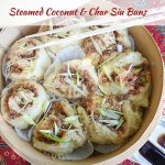 Steamed Coconut & Char Siu Buns in a bamboo steamer with accompaniments of soy & chilli sauce and a set of chopsticks