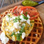 Corn waffles with feta, roasted tomatoes and chimichurri sauce