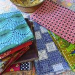 Lengths of colourfully printed fabric from Kenya, Indonesia, Tanzania and Fiji