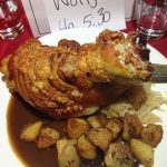 Large pork knuckle with crackling sits atop a plate of potatoes, sauerkraut and gravy at the Brisbane German Club