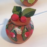 Pottery bowl decorated with painted pottery bloodwood apples. From the Hermannsburg Potters Bush Tucker series - QAGOMA