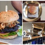 burger with onion rings on top; burger on a plate; meat grinders used as decoration in the restaurant
