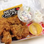 Pieces of NeNe Chicken in a lunch box with accompaniments